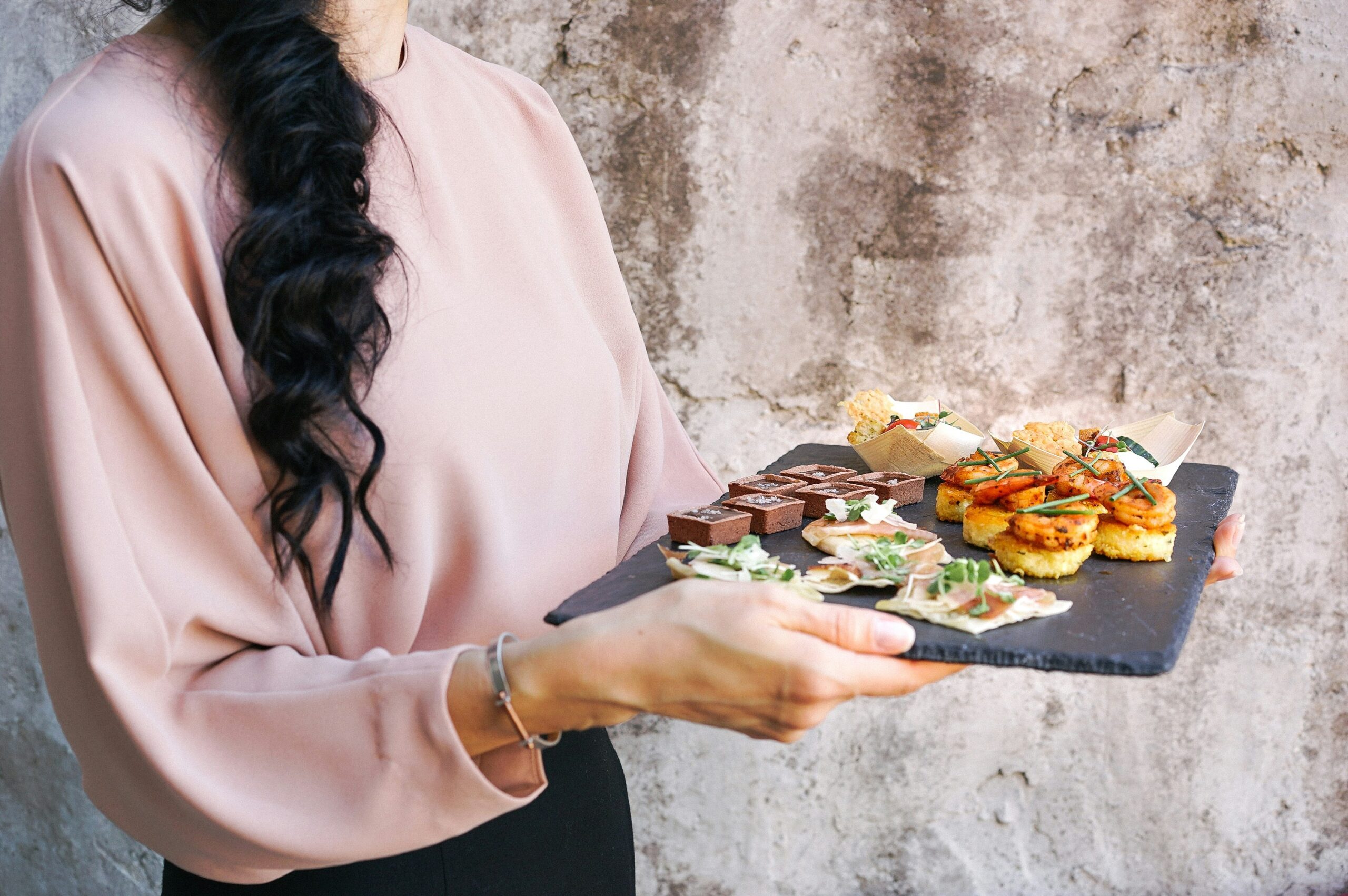 Photo of a happy customer holding a plate of healthy food delivered by BistroMD