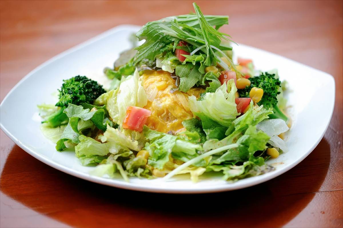 Healthy snack options including almonds, apple slices, and hummus on a wooden board.