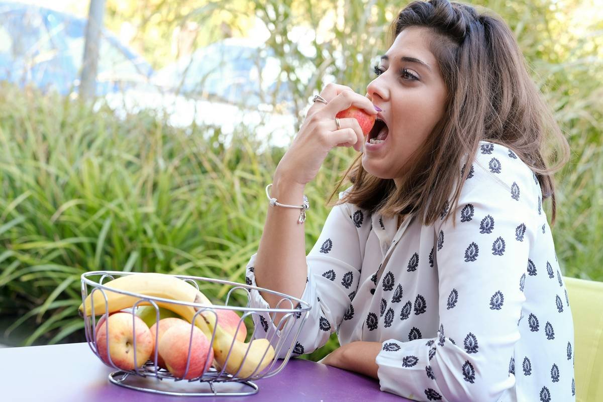 Pregnant woman enjoying a prepared meal from a diet for healthy pregnancy service